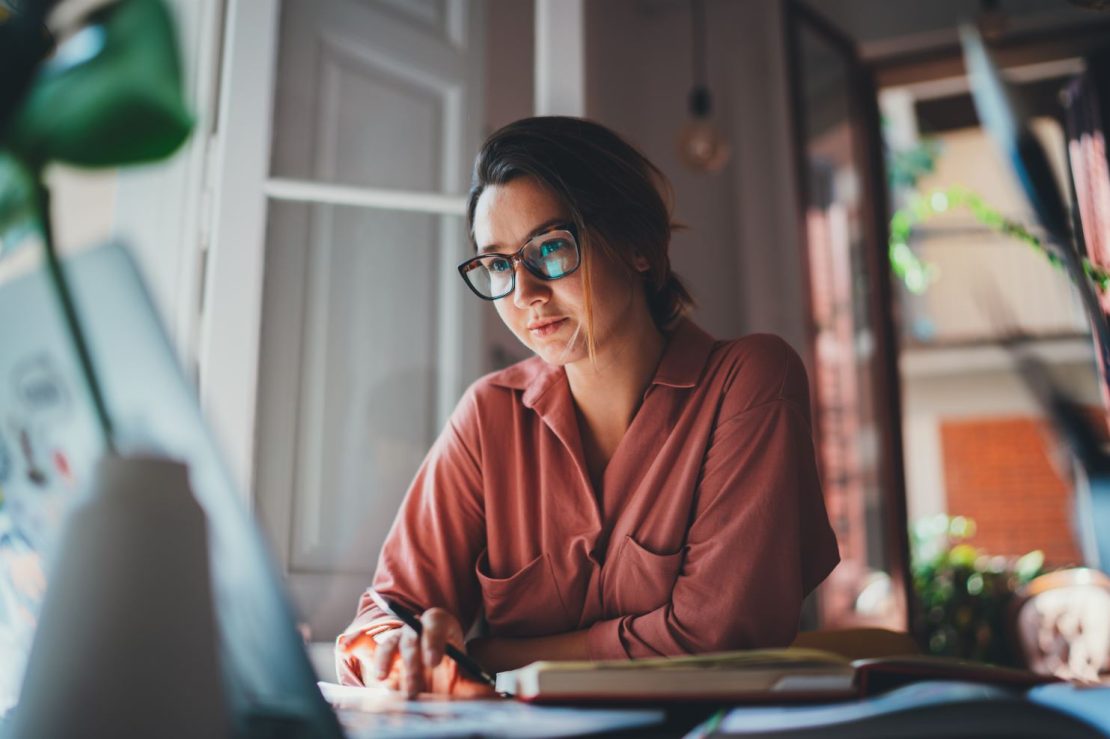 Woman watching a video on her laptop at home
