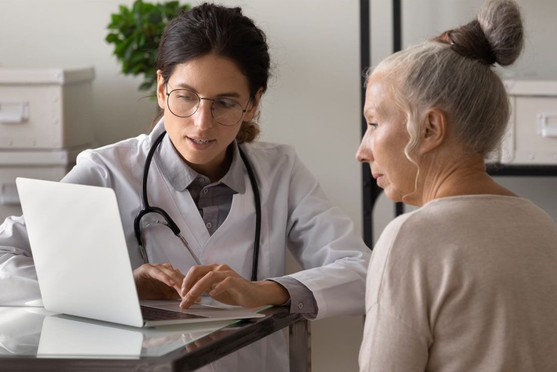A doctor explains medicine options to a female patient,