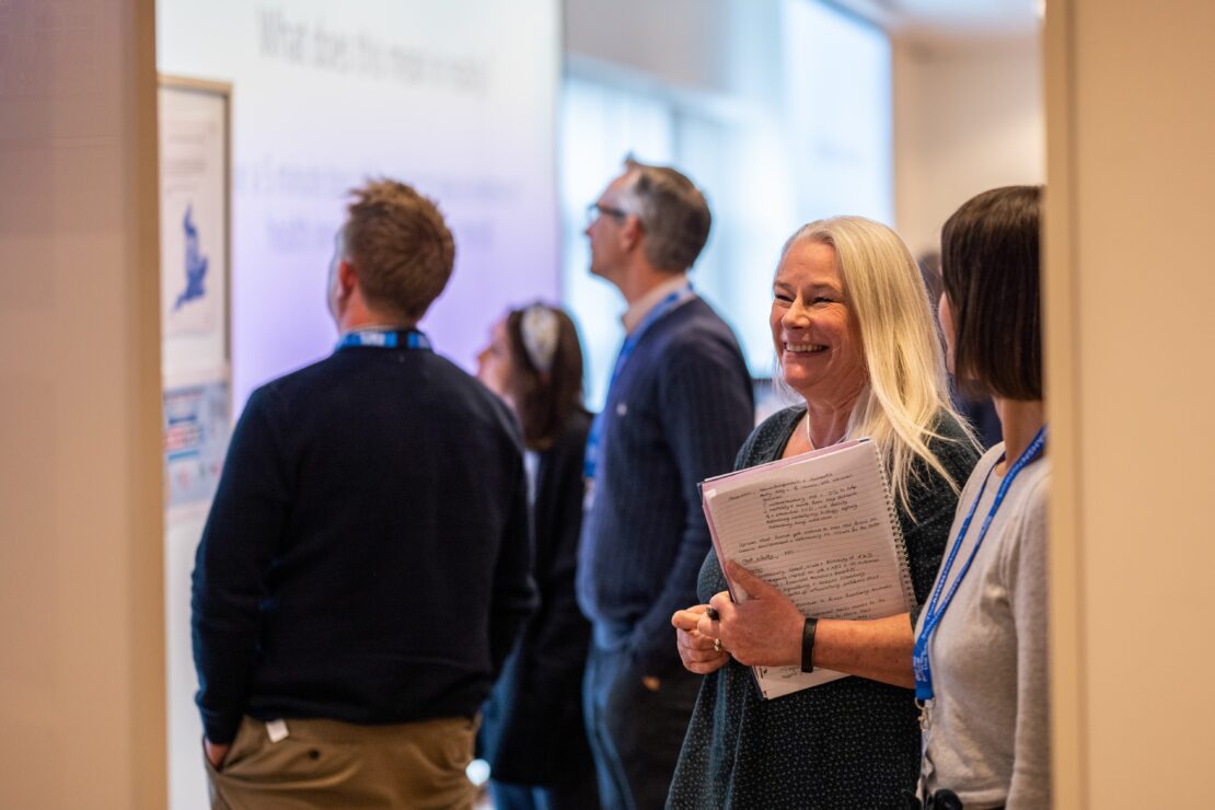 people talking and laughing at conference