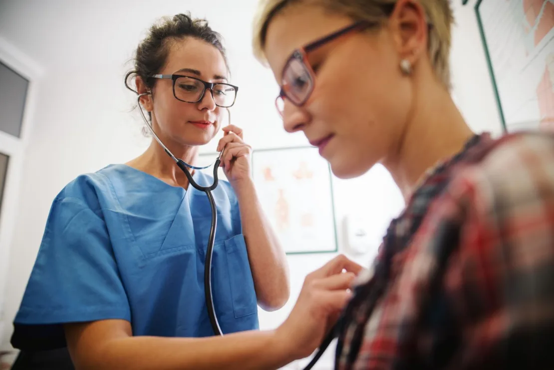 nurse taking heartrate of patient