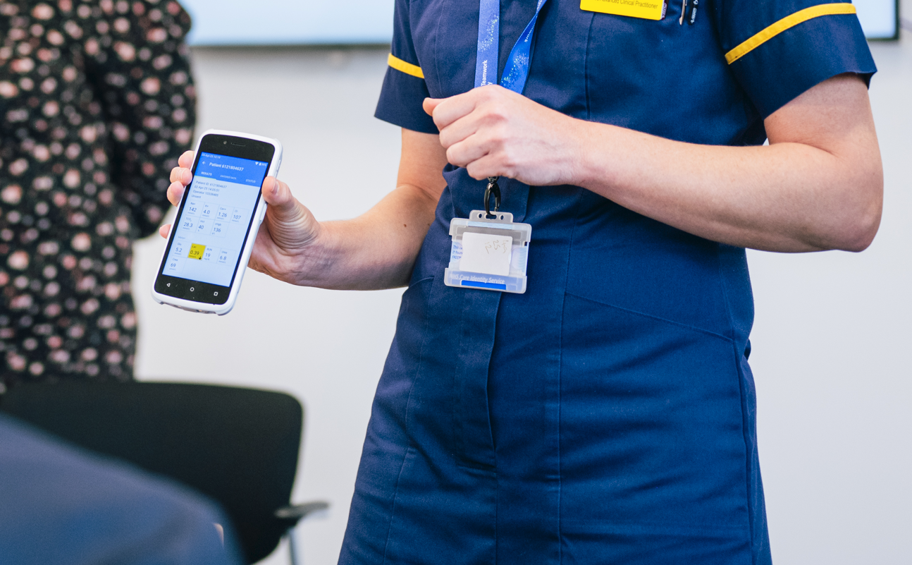 Nurse holding POCT machine