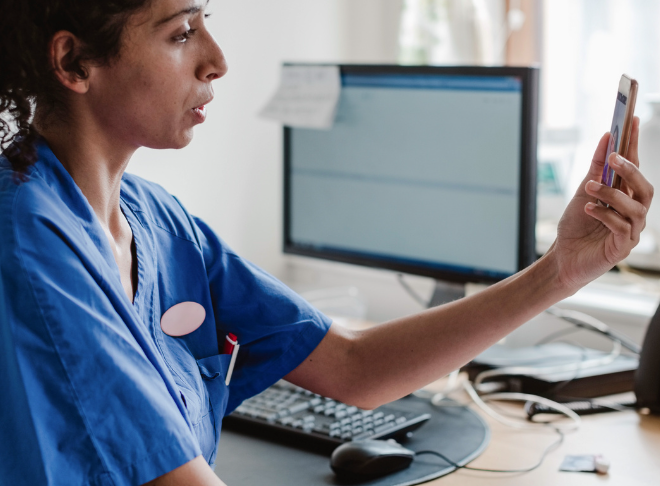 Doctor on video call on phone with patient