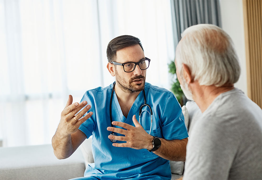 nurse talking with older male patient