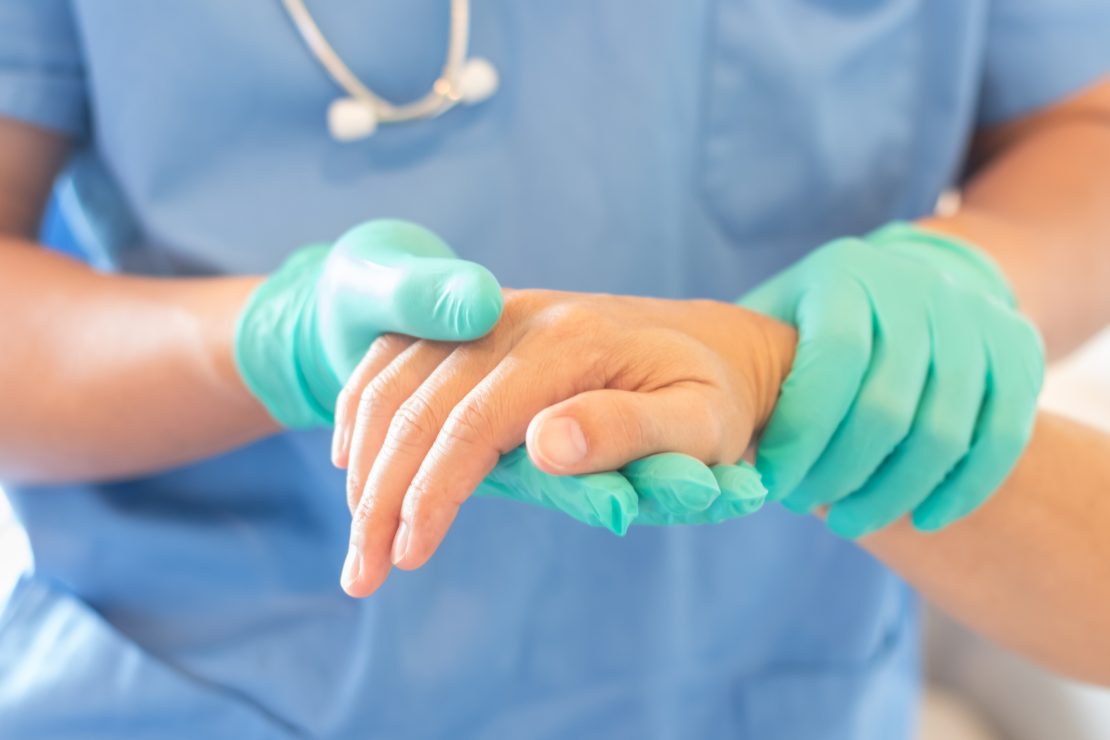 Clinician holding a patient's hand