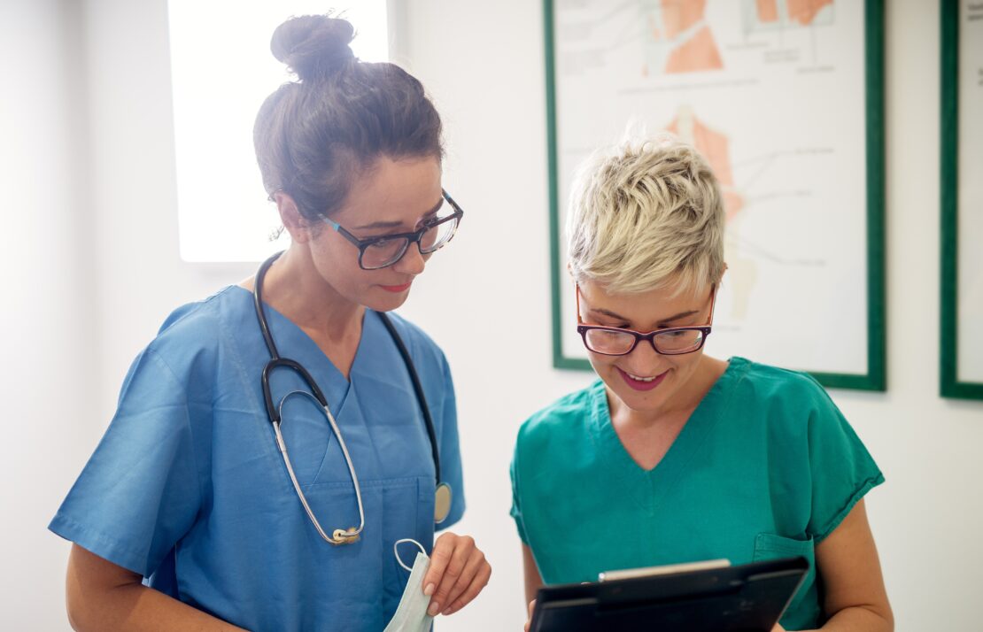 Professional nurses looking through some patients medical papers.