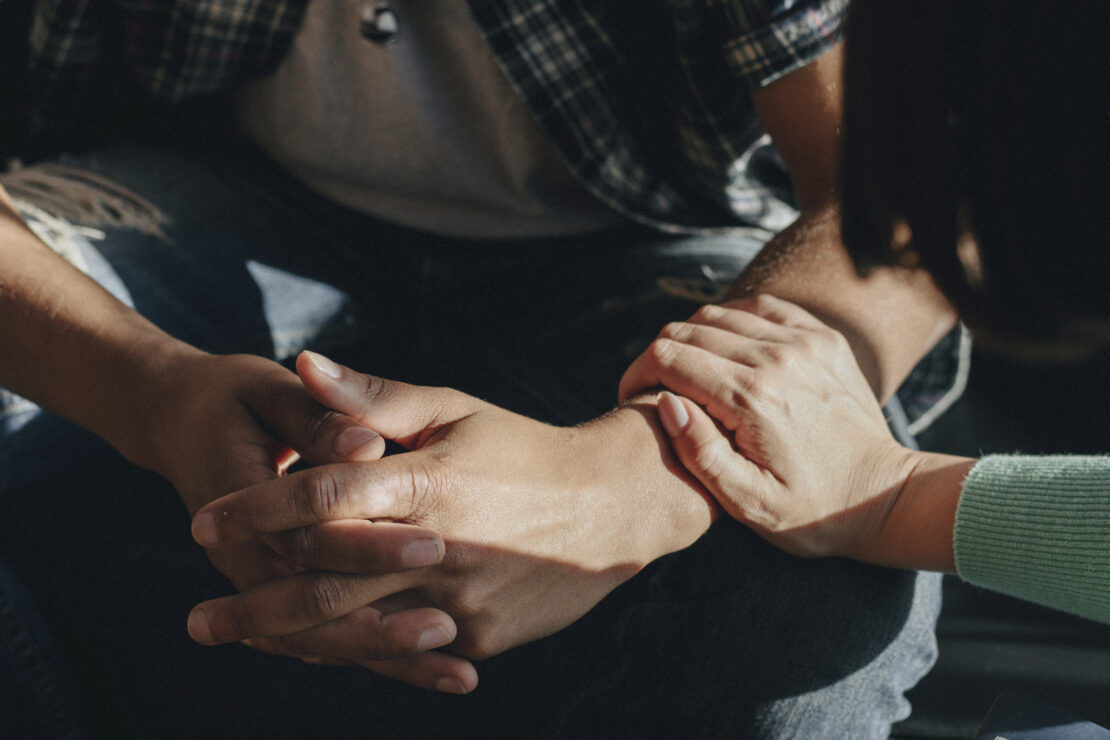 A woman consoling a young man