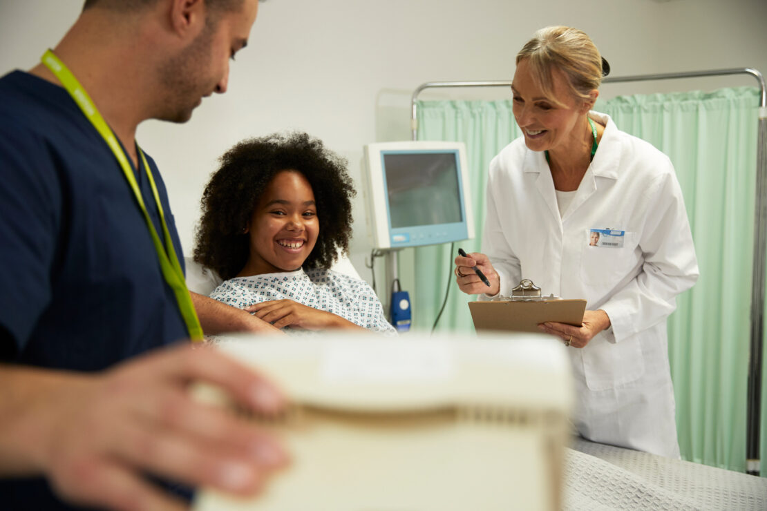 Healthcare worker examining patient in medical room at hospital