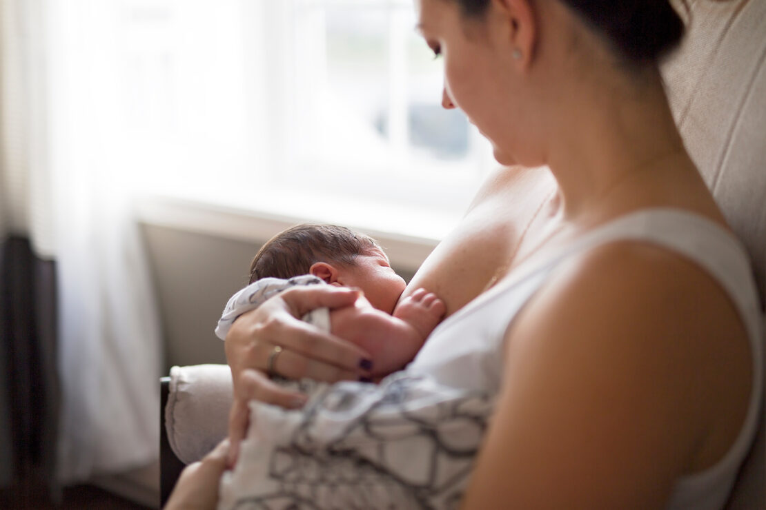 A Mother breastfeeding her baby in her arms
